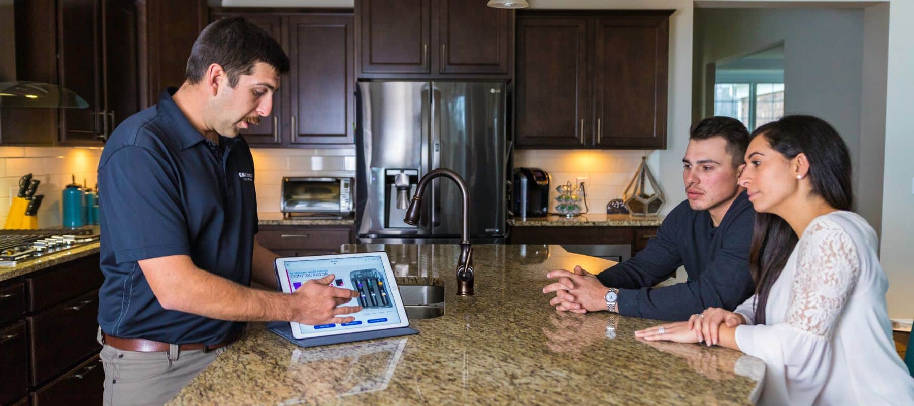aquazona and kinetico of tucson professional going through a water test with two homeowners in their tucson home