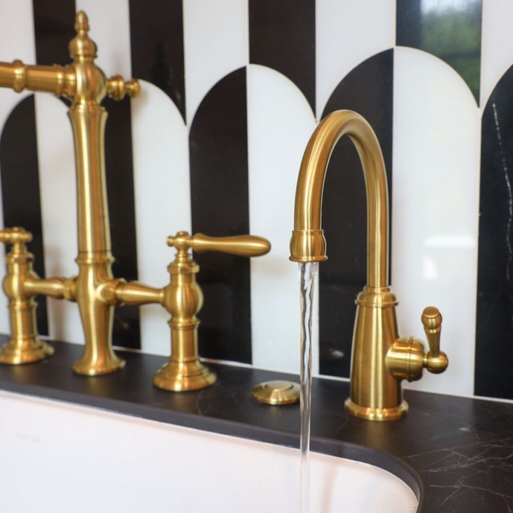 gold sink fixtures in a commercial bathroom
